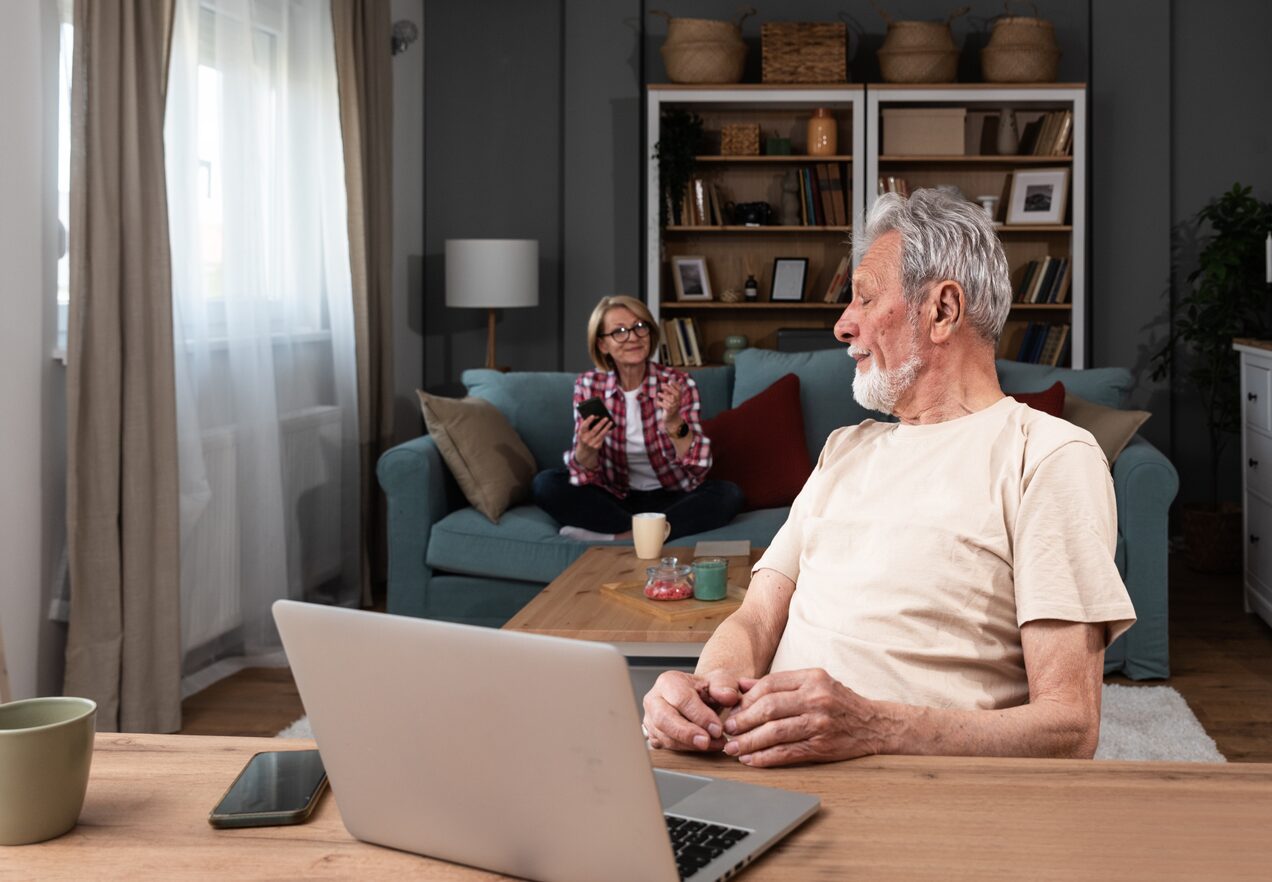 GettyImages-1571669064 A man and woman sitting at a table with a laptop.