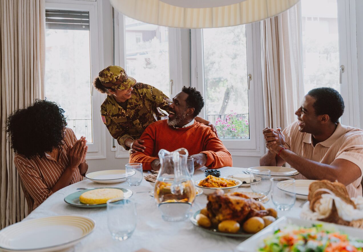 GettyImages-2191030911 A group of people sitting at the table eating food.