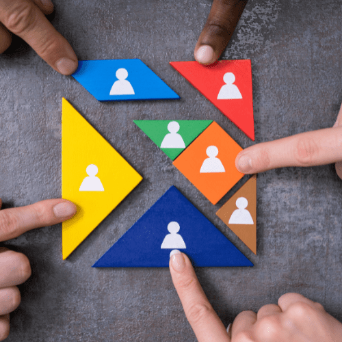 Fingers pointing at colorful puzzle pieces.