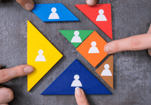 Fingers pointing at colorful puzzle pieces.
