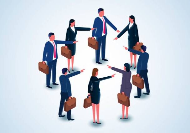 Businesspeople pointing fingers in a circle formation.