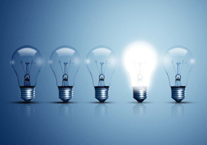 Five light bulbs, one brightly lit.